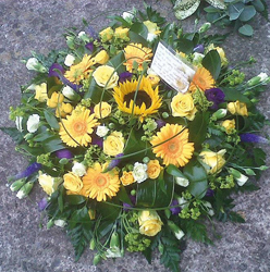 Yellow and purple funeral tribute flower and foliage posy